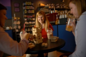 CHASS' Amanda Boykin plays Jenga with friends in an off campus coffee house. 