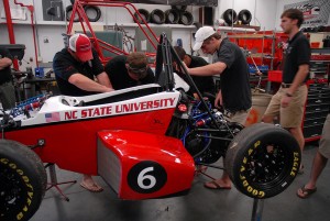 Members of Wolfpack Motorsports work on their latest car. 